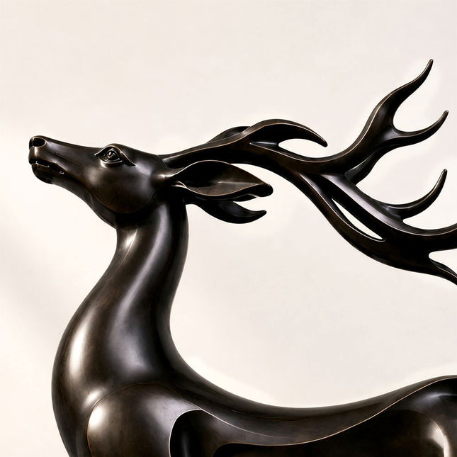 Open-form bronze body and integrated base detail on the leaping deer sculpture