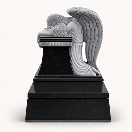 Front view of weeping angel headstone with carved wings and black granite monument