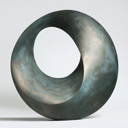 Abstract bronze sculpture with a continuous circular form and open center