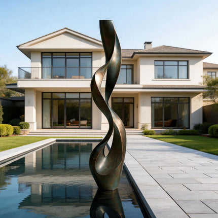 Tall abstract bronze sculpture with flowing curves beside a modern pool
