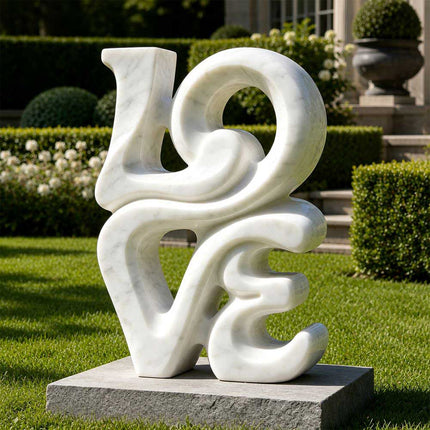 Abstract white marble sculpture displayed on a lawn in a formal garden