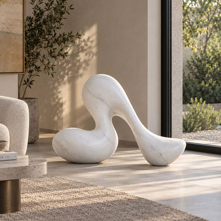 Abstract white marble sculpture with smooth organic curves in a modern interior