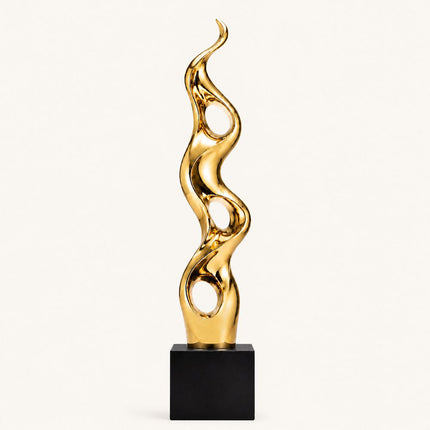 Gold abstract sculpture with three circular openings and flowing vertical form