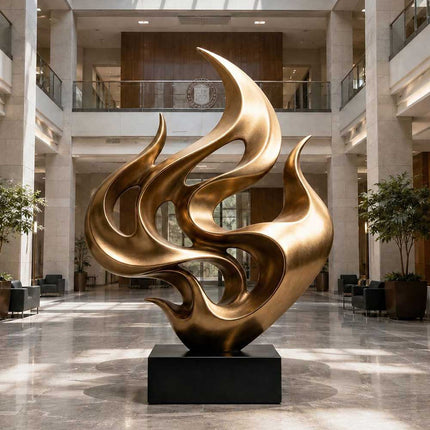 Large abstract bronze sculpture displayed in a contemporary lobby