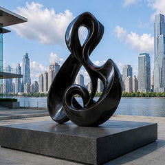 Contemporary abstract sculpture in a modern architectural setting, designed for outdoor public and commercial spaces.