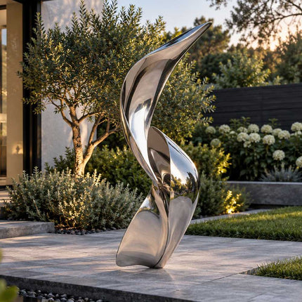 Abstract stainless steel sculpture with intertwined flowing forms in a modern garden