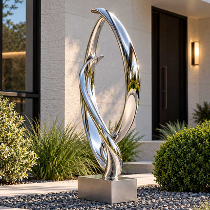 Side view of an abstract stainless steel loop sculpture showing its layered curved metal forms in a contemporary residential garden