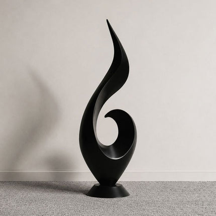 Ascending flame abstract sculpture in matte black stainless steel with a flowing vertical form