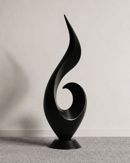 Ascending flame abstract sculpture in matte black stainless steel with a flowing vertical form