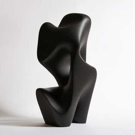 Front view of black bronze sculpture with rounded organic curves and open negative spaces