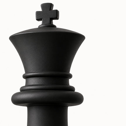 Close-up of a matte black chess king sculpture showing its cross-shaped top and stepped circular details.