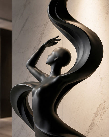 Close-up detail showing the flowing curves and matte black surface of stainless steel sculpture