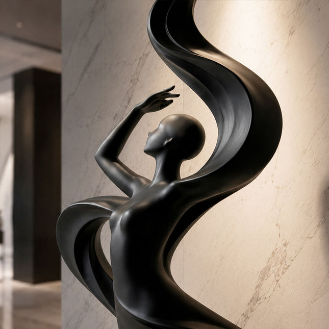 Close-up detail showing the flowing curves and matte black surface of stainless steel sculpture