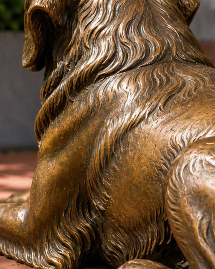 Detailed handcrafted bronze dog sculpture showing textured fur and patina finish