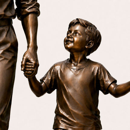 Child figure looking up while holding a parent's hand in the bronze family sculpture