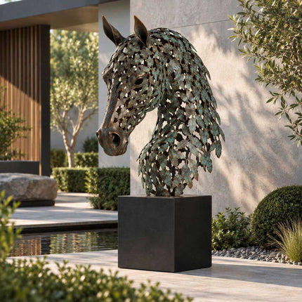 Leaf-inspired bronze horse head sculpture on a dark pedestal beside a private garden water feature
