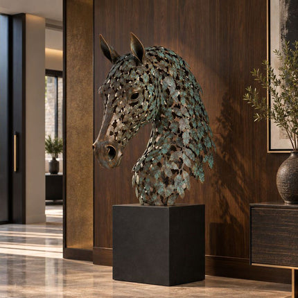 Bronze horse head sculpture with layered leaf-shaped elements displayed in a dark wood interior
