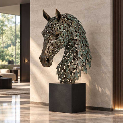 Openwork bronze horse head sculpture displayed against a stone wall in a modern interior