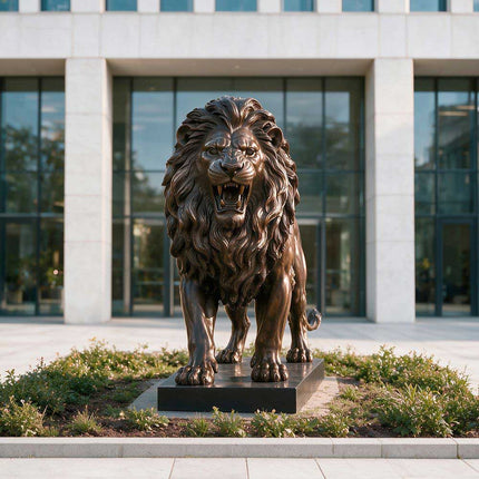 Bronze lion sculpture positioned in a landscaped commercial entrance