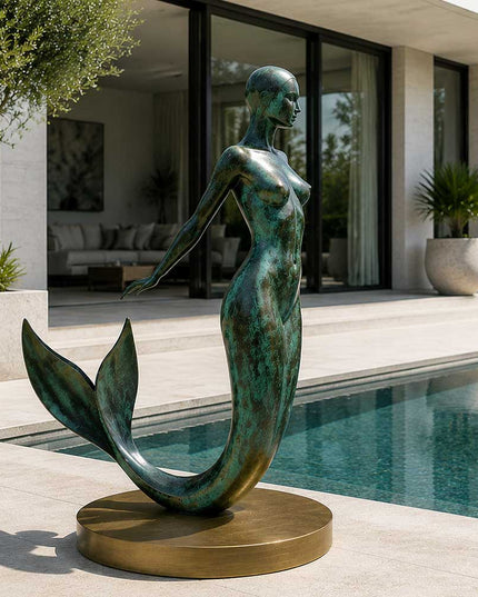 Bronze mermaid sculpture installed beside a modern pool courtyard
