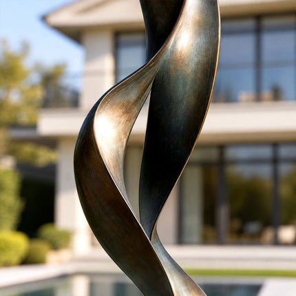 Close-up of the twisting bronze surfaces and narrow opening of an abstract sculpture