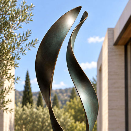 Close-up of two upward-curving bronze ribbon forms with dark green patina and warm bronze edges