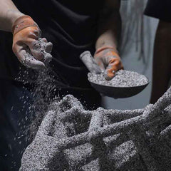 Applying refractory investment material to create a ceramic shell for lost-wax bronze casting