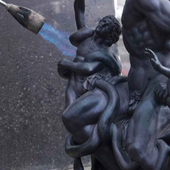 Applying a handcrafted patina to enhance the color and character of a bronze sculpture
