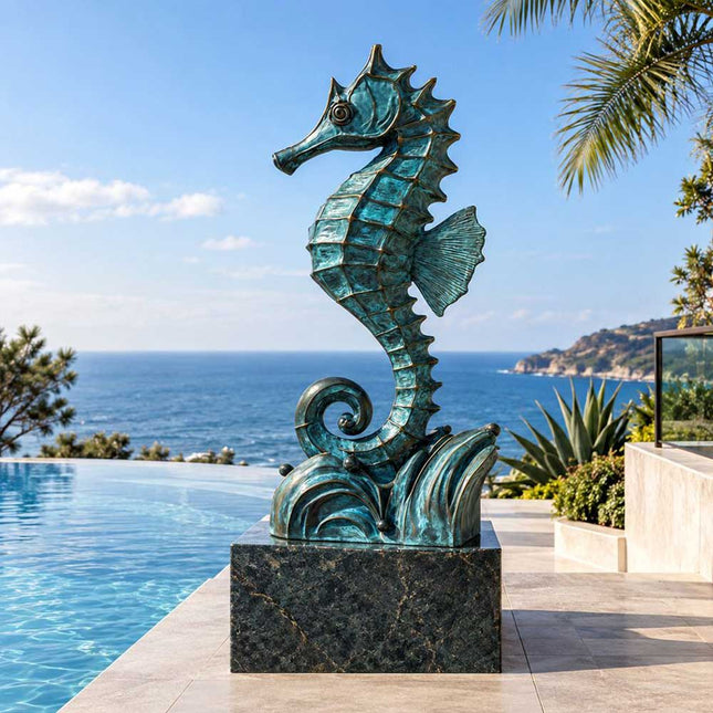 Blue patina bronze seahorse sculpture displayed on a dark stone pedestal beside a residential infinity pool overlooking the ocean