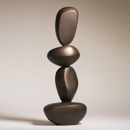 Bronze sculpture composed of four vertically stacked pebble-like forms