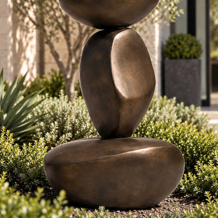 Close-up of the lower stacked forms and dark bronze surface