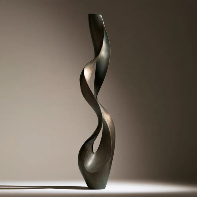 Abstract bronze sculpture with a tall twisting ribbon form and narrow openings