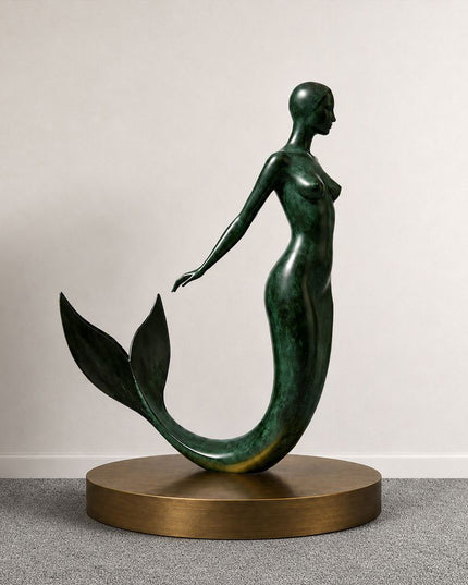 Cast bronze mermaid sculpture displayed in a contemporary interior setting