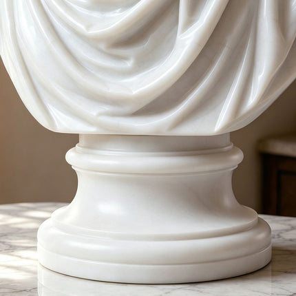 Detailed carving of marble drapery and pedestal on a classical bust sculpture