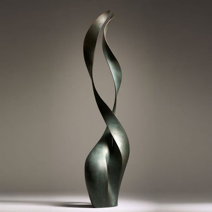Contemporary bronze sculpture with two intertwined ribbon forms and dark green patina