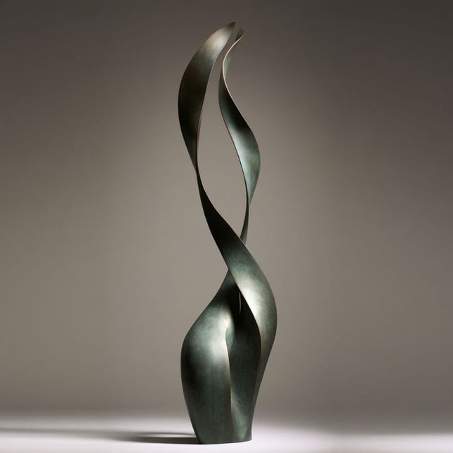 Contemporary bronze sculpture with two intertwined ribbon forms and dark green patina