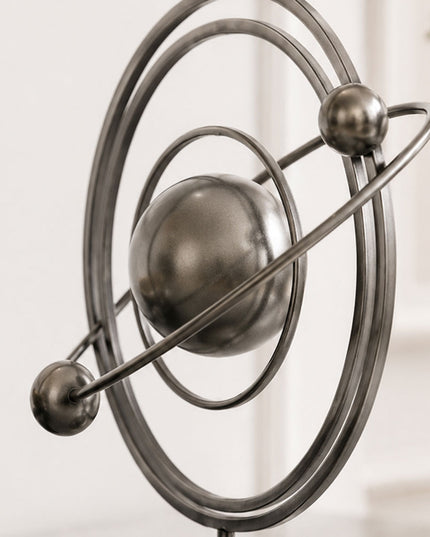 Detail view of contemporary stainless steel sculpture featuring orbital inspired metal rings