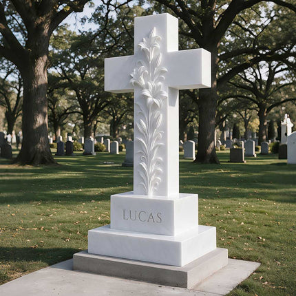 Three-quarter view of a white cross headstone with raised lily carvings in a cemetery