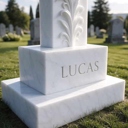 Close-up of the personalized inscription block and stepped base of a cross headstone