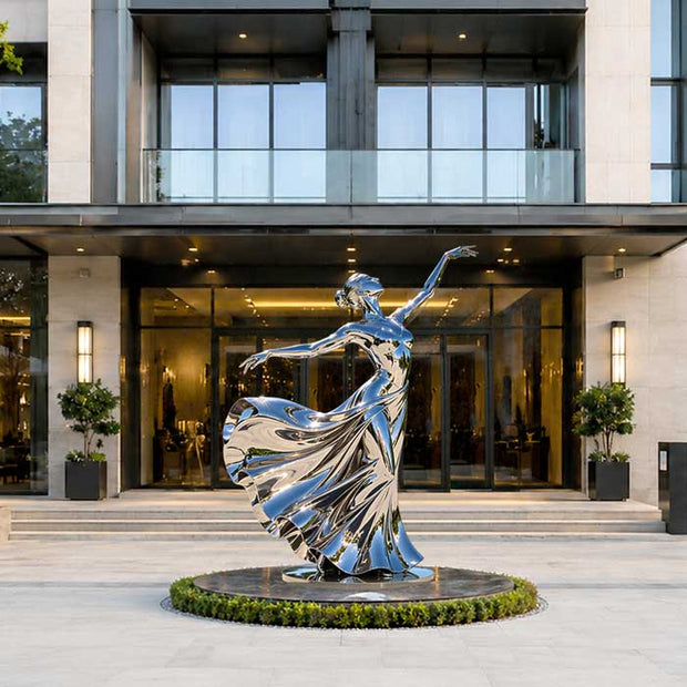 A stainless steel dancing girl sculpture proportionally scaled to the environment, creating visual balance and a harmonious relationship with the surrounding space.