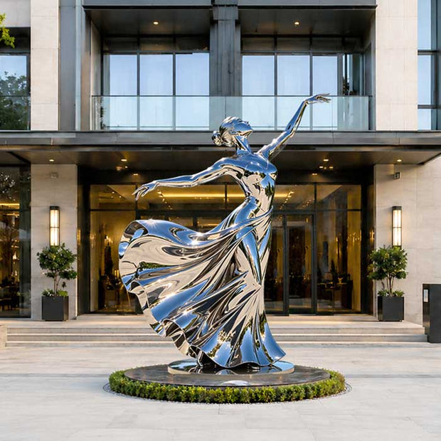 A stainless steel dancing girl sculpture that is oversized for the space, dominating the environment and overpowering the surrounding architectural context.