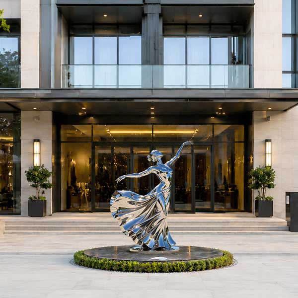 A stainless steel dancing girl sculpture appearing undersized within the surrounding space, resulting in reduced visual presence and weak spatial balance.