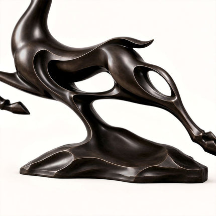 Open-form bronze body and integrated base detail on the leaping deer sculpture