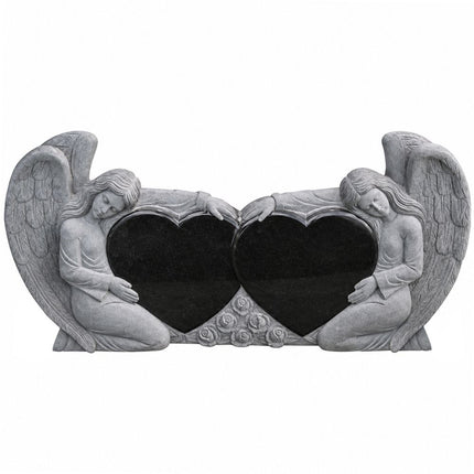 Black granite double heart headstone framed by two carved angels and feathered wings