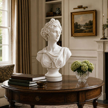Draped female marble bust displayed on a wooden table in a traditional interior