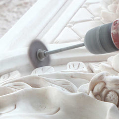 Final polishing of intricate marble details to enhance the natural beauty of the stone.
