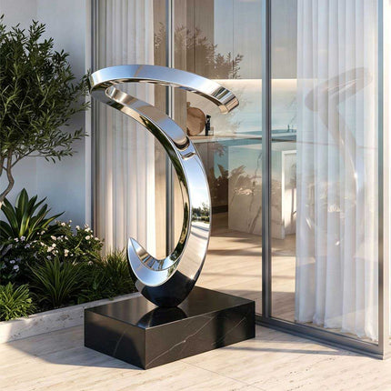 Mirror polished stainless steel abstract sculpture installed in a contemporary residential space