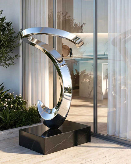Mirror polished stainless steel abstract sculpture installed in a contemporary residential space