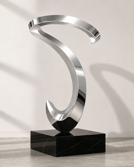Flowing loop abstract sculpture in mirror polished stainless steel with stone base