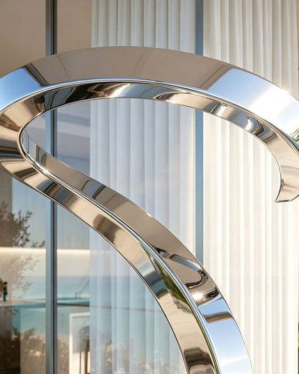 Close-up of mirror polished surface and curved form on abstract stainless steel sculpture